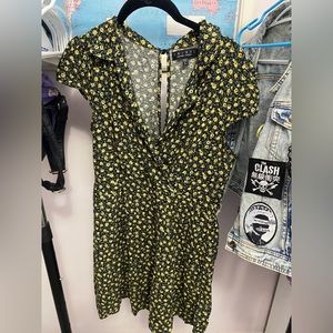 Great little summer dress, low cut , and button on the back. Light and flowy